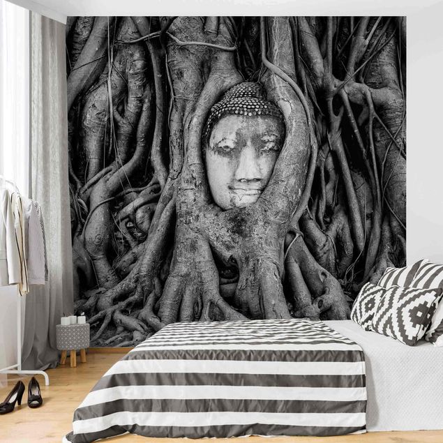 Papel pintado salón moderno Buddha In Ayutthaya Lined From Tree Roots In Black And White